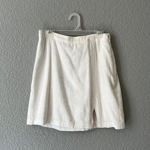 White skirt with zipper on the side. Has a slip underneath so not see through.
